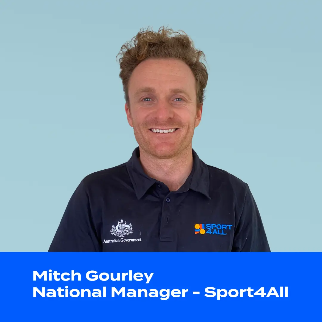 In the image, Mitch Gourley, a Caucasian male with brown hair, is looking directly at the camera. He is wearing a blue Sport4All shirt.