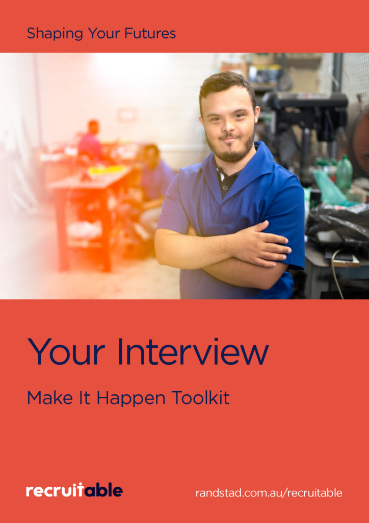 The image has a red background with the heading "Shaping your futures" in dark blue text at the top. Below the heading, there is an image of a man standing with his arms crossed, smiling at the camera. He is in a factory setting, visible in the background. Below the man's image, large bold text reads, "Your Interview" and "Make it Happen Toolkit." At the bottom of the image, the Recruitable logo is displayed, along with the URL: https://www.randstad.com.au/recruitable/.