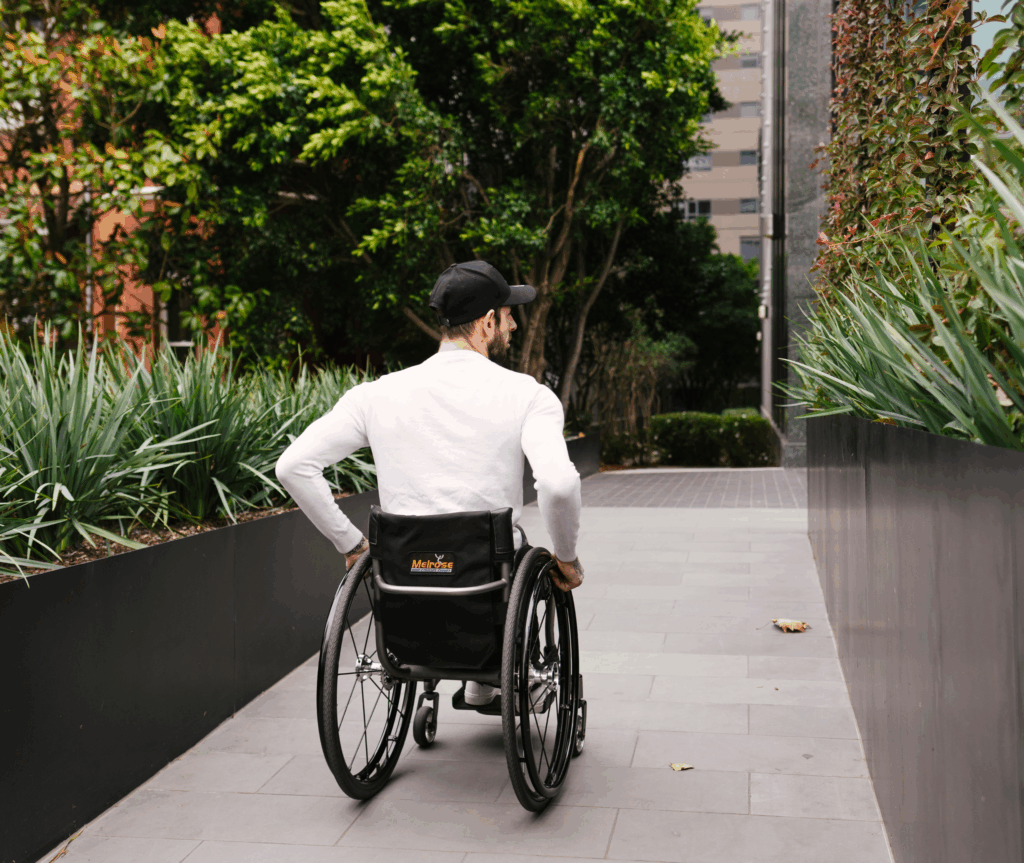 Man on wheelchair entering a building