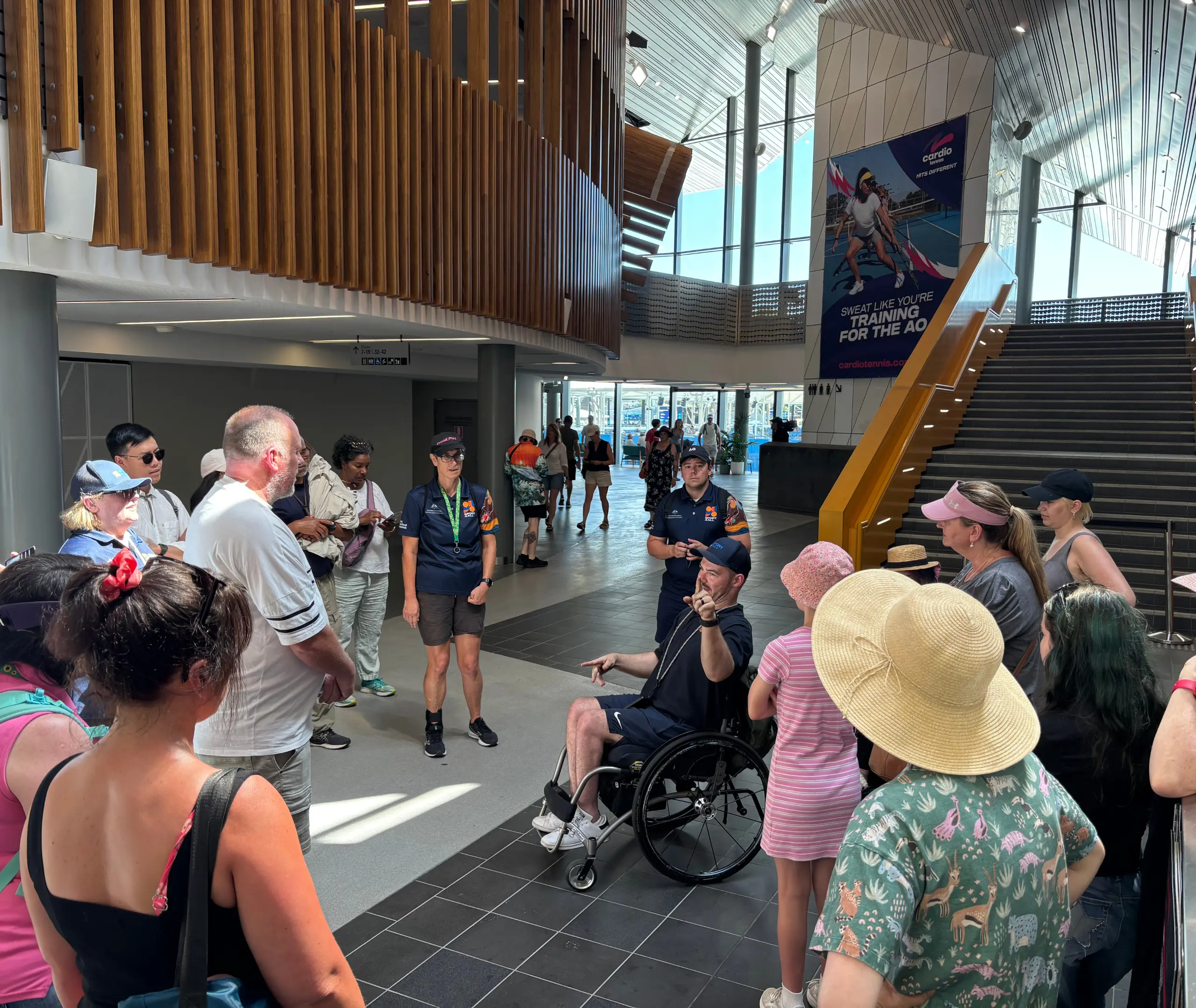 Jeremy from Sport4All, in a Sport4All polo, holds an AO sensory bag and speaks to a crowd while showing items from the bag.