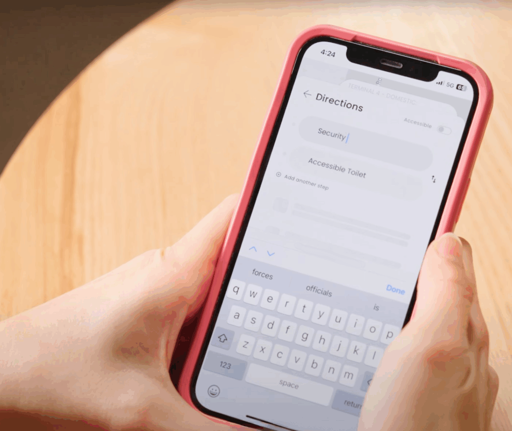 A close-up of a smartphone screen displaying travel directions, with an icon highlighting the option for accessible toilets.