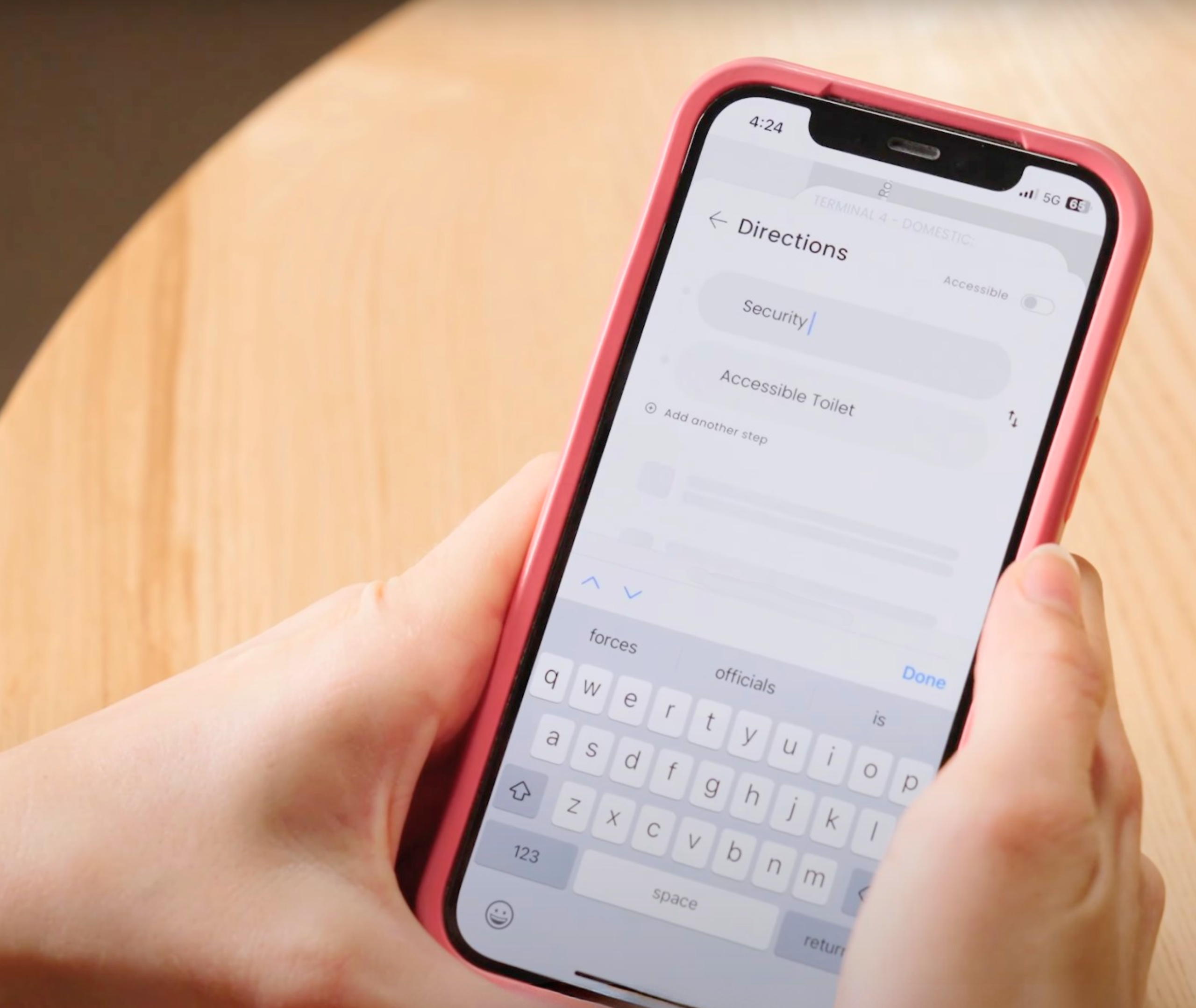 A close-up of a smartphone screen displaying travel directions, with an icon highlighting the option for accessible toilets.
